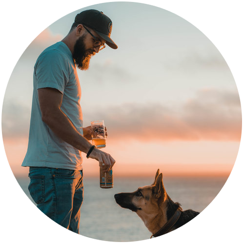 Matt Minkus the co-founder of Captain Fatty's on the beach with his dog